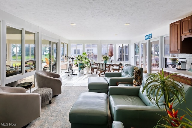 living room featuring a wealth of natural light and a textured ceiling