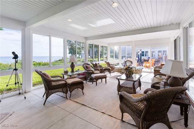 sunroom / solarium featuring beam ceiling