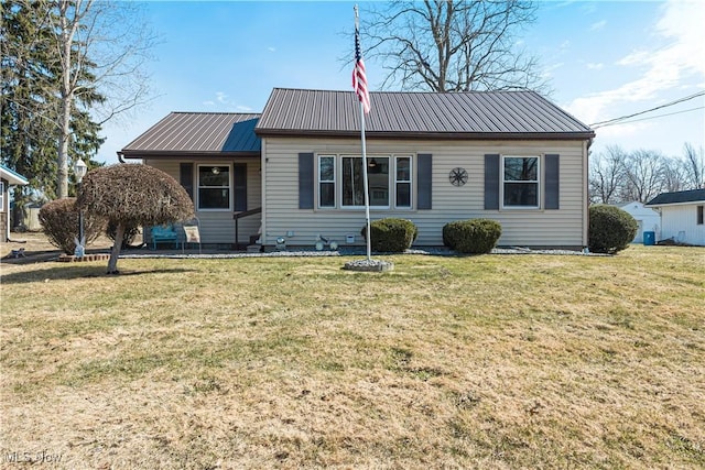 view of front of house featuring a front yard and metal roof