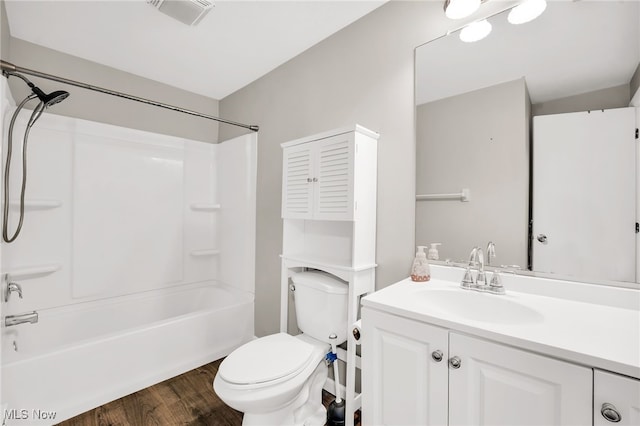 full bathroom featuring vanity, wood finished floors, visible vents, shower / bathing tub combination, and toilet