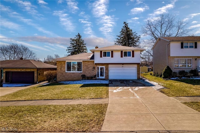 tri-level home featuring driveway, an attached garage, and a front yard