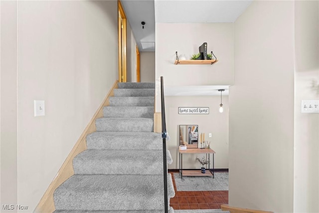 stairs featuring baseboards