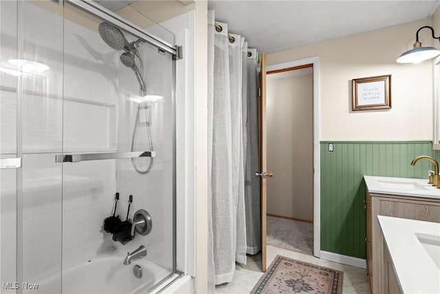 bathroom with vanity, wainscoting, and enclosed tub / shower combo