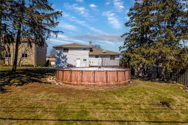 view of yard featuring a pool and fence