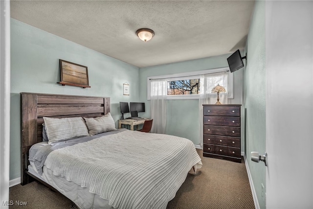 carpeted bedroom with baseboards and a textured ceiling