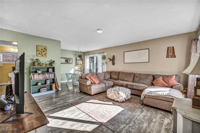 living room featuring baseboards and wood finished floors