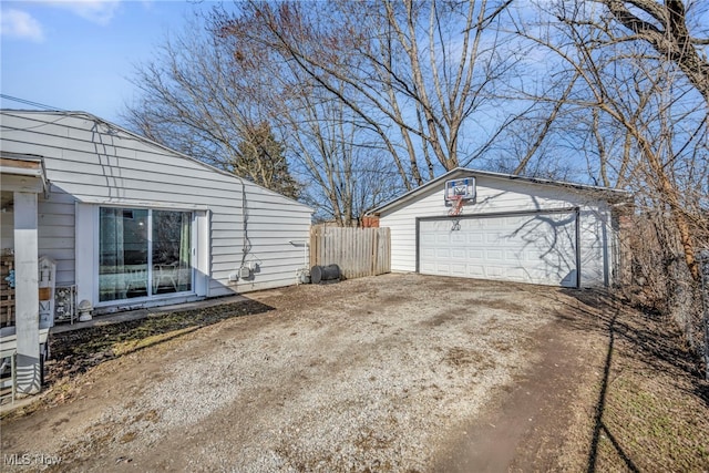 detached garage featuring fence