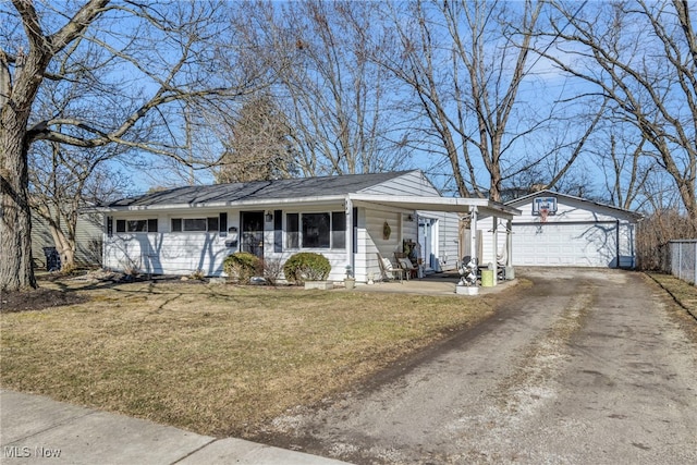 single story home with driveway, a porch, an outdoor structure, an attached garage, and a front yard