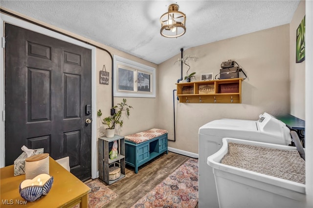 laundry area with laundry area, wood finished floors, baseboards, and a textured ceiling