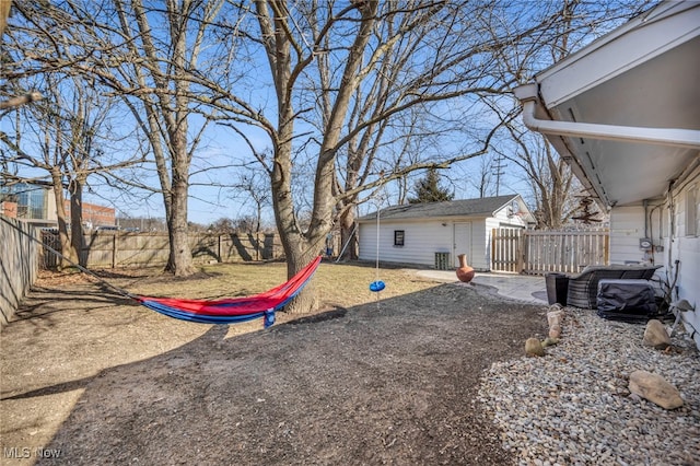 view of yard featuring an outdoor structure and a fenced backyard