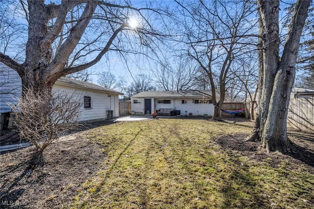 back of house featuring a patio area, central air condition unit, fence, and a lawn