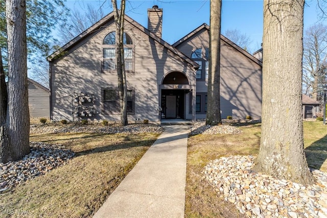 view of front of property with a front lawn and a chimney