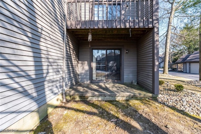 view of exterior entry featuring a patio area