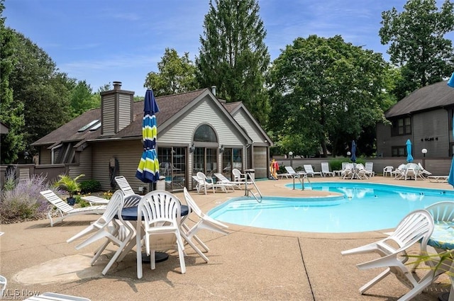 pool featuring a patio and fence