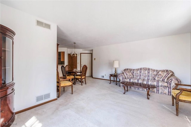 living room with visible vents, carpet floors, and a notable chandelier