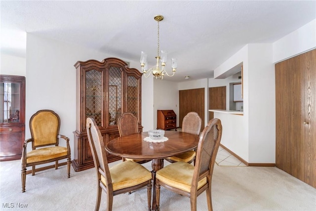 dining room with baseboards, light colored carpet, and an inviting chandelier