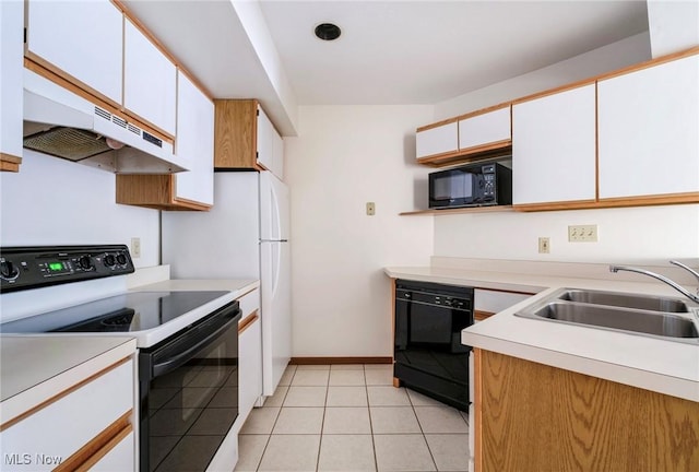 kitchen with black appliances, a sink, under cabinet range hood, light countertops, and light tile patterned floors