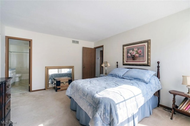 bedroom with light carpet, visible vents, ensuite bath, and baseboards