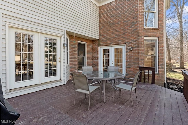 deck with outdoor dining area and french doors