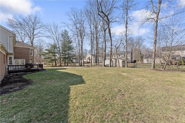 view of yard featuring a deck and fence