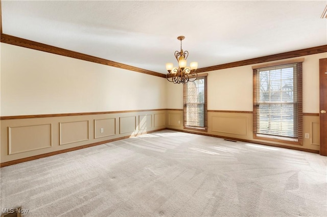 unfurnished room with ornamental molding, visible vents, a chandelier, and light carpet