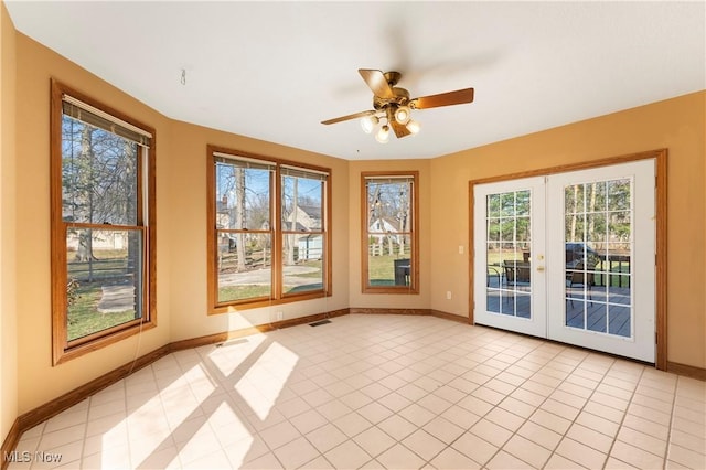 unfurnished sunroom with french doors, visible vents, and a ceiling fan