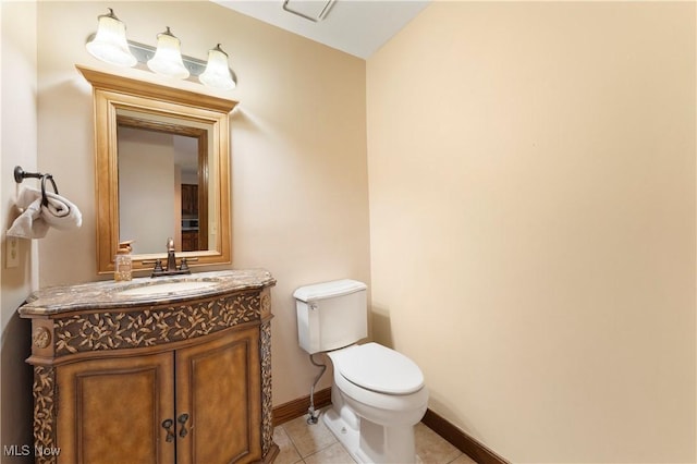 half bathroom with baseboards, toilet, vanity, and tile patterned flooring