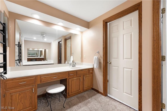 bathroom featuring baseboards, vanity, and a ceiling fan