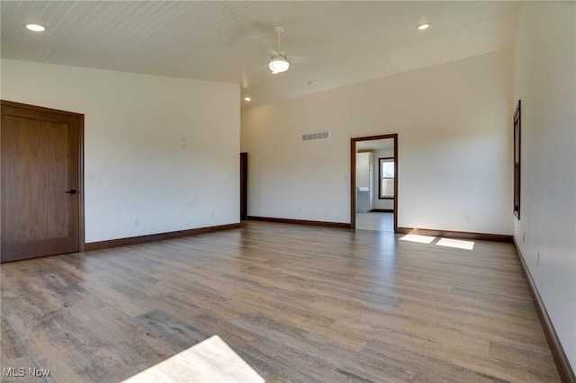 unfurnished room with visible vents, baseboards, and wood finished floors