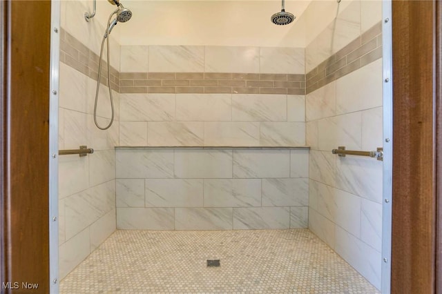 bathroom with a tile shower