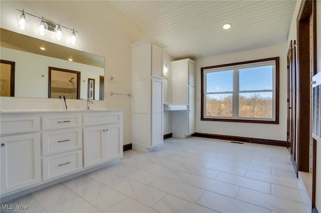 full bath with a sink, a shower, wood ceiling, and double vanity