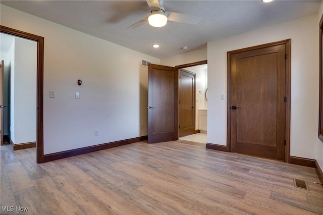 unfurnished bedroom featuring visible vents, baseboards, and light wood-style flooring