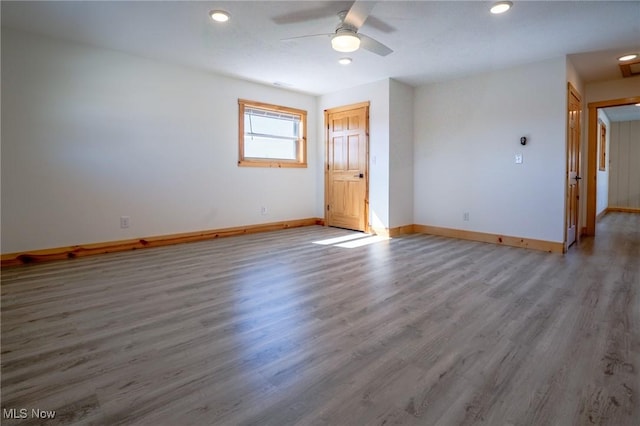 empty room with recessed lighting, ceiling fan, baseboards, and wood finished floors