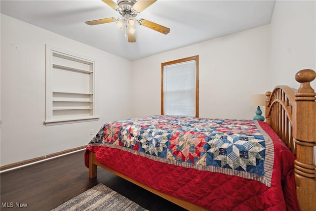 bedroom with a ceiling fan, baseboards, and wood finished floors