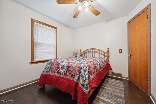 bedroom featuring ceiling fan, baseboards, and wood finished floors