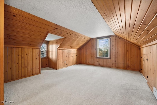 bonus room with lofted ceiling, carpet, wood walls, and wooden ceiling