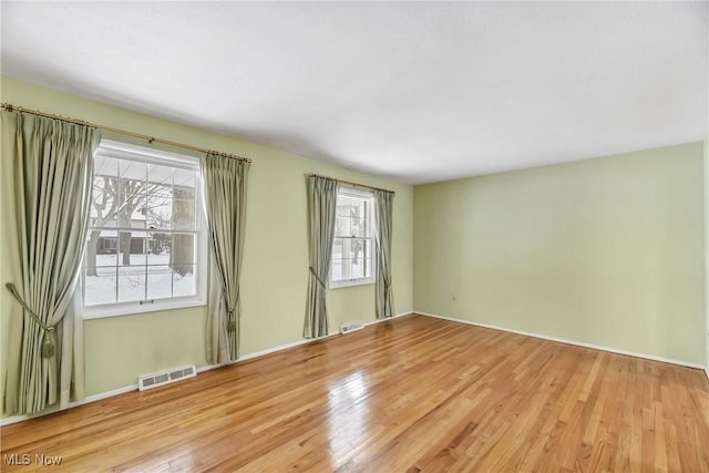 spare room with visible vents and wood finished floors