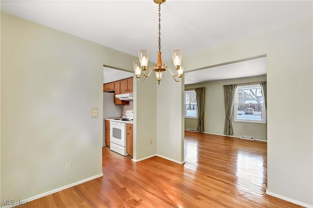 unfurnished dining area with visible vents, baseboards, an inviting chandelier, and light wood finished floors