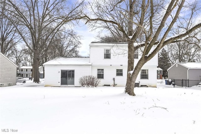 view of snow covered rear of property