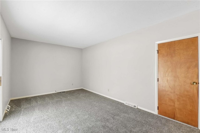 unfurnished room featuring visible vents, baseboards, and carpet