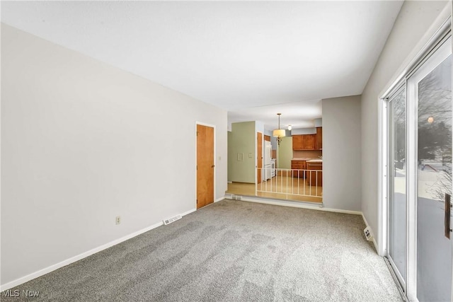 spare room featuring visible vents, baseboards, and light colored carpet