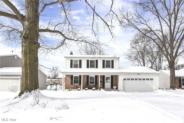 view of front of home with brick siding and a garage