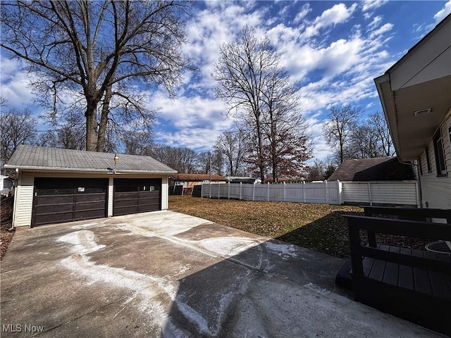 view of yard with a garage, an outdoor structure, and fence