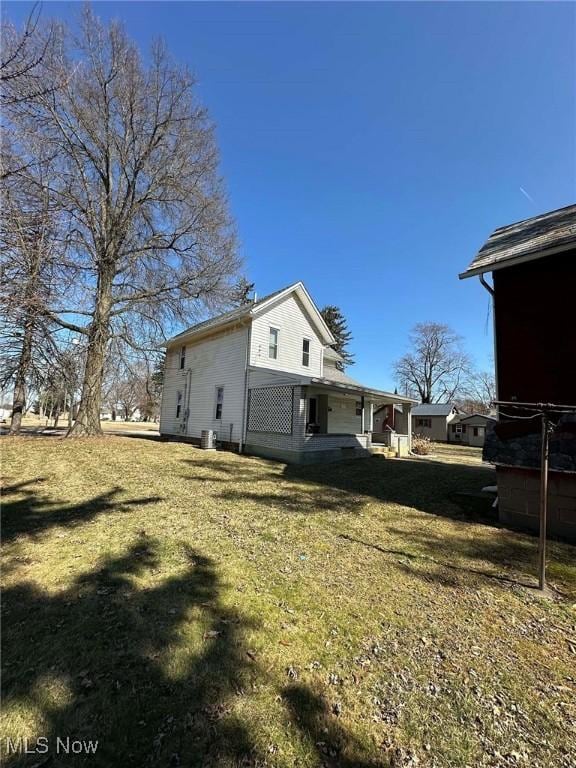 view of side of home with a lawn