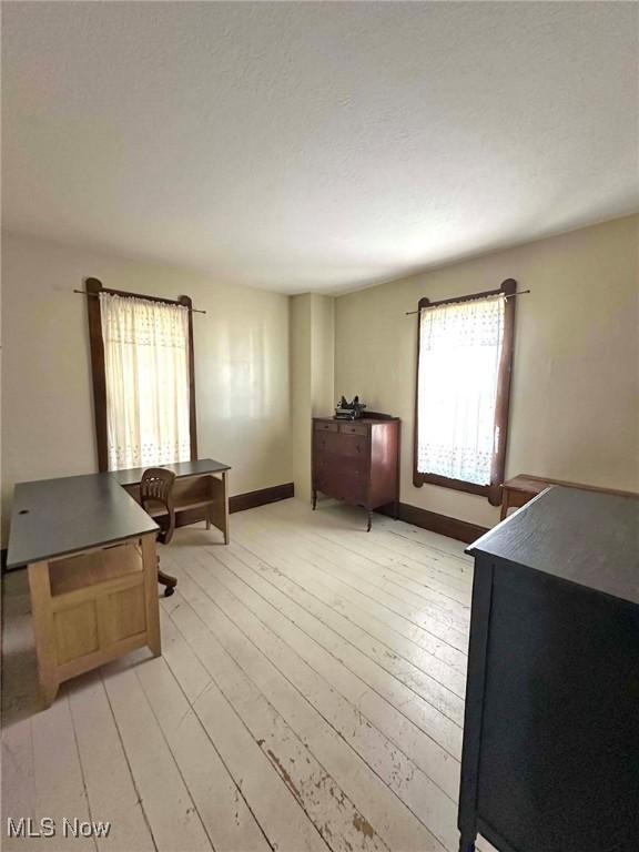 interior space featuring baseboards and light wood-type flooring