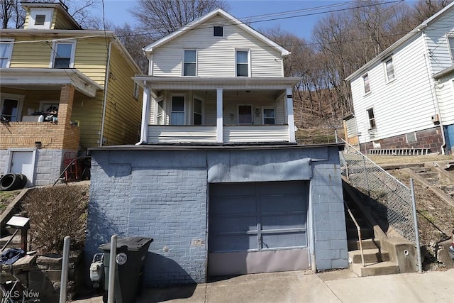 view of front of home with driveway, a garage, and fence