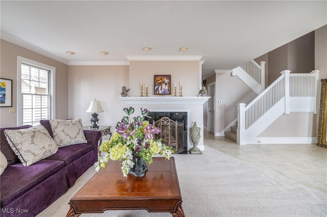 carpeted living room with tile patterned flooring, crown molding, stairway, and a fireplace