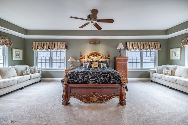 bedroom with baseboards, multiple windows, and carpet flooring