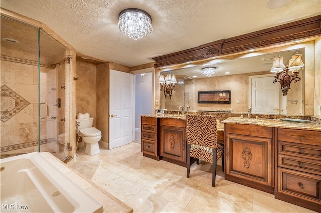 full bath with vanity, a stall shower, a textured ceiling, a garden tub, and toilet