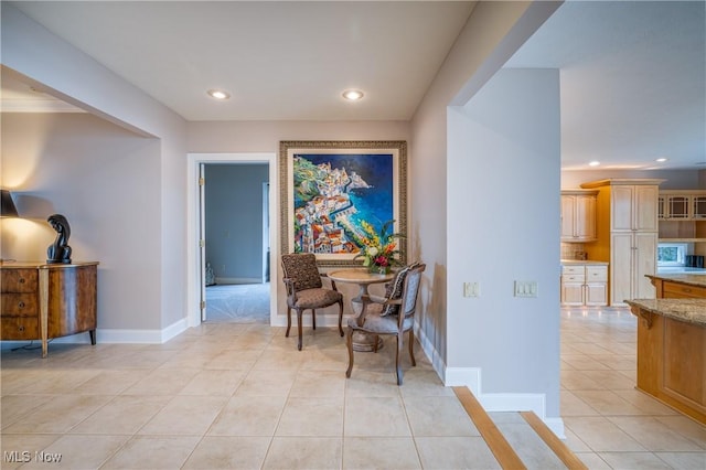 hallway featuring light tile patterned flooring, recessed lighting, and baseboards